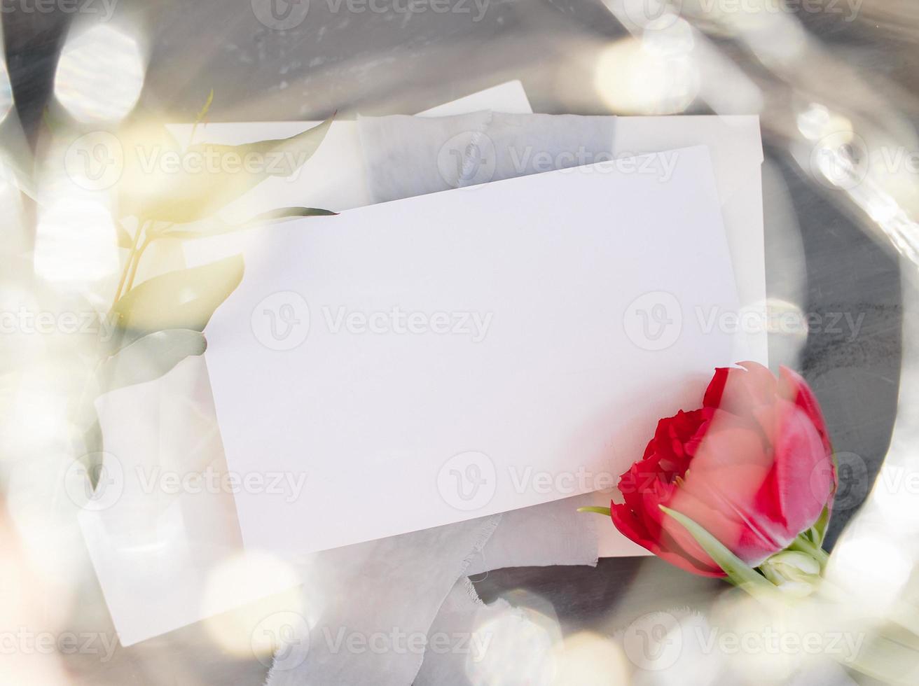 Blank paper copy space. Frame with flowers. Silk ribbon. Gray background. Simple bouquet. Greeting card. photo