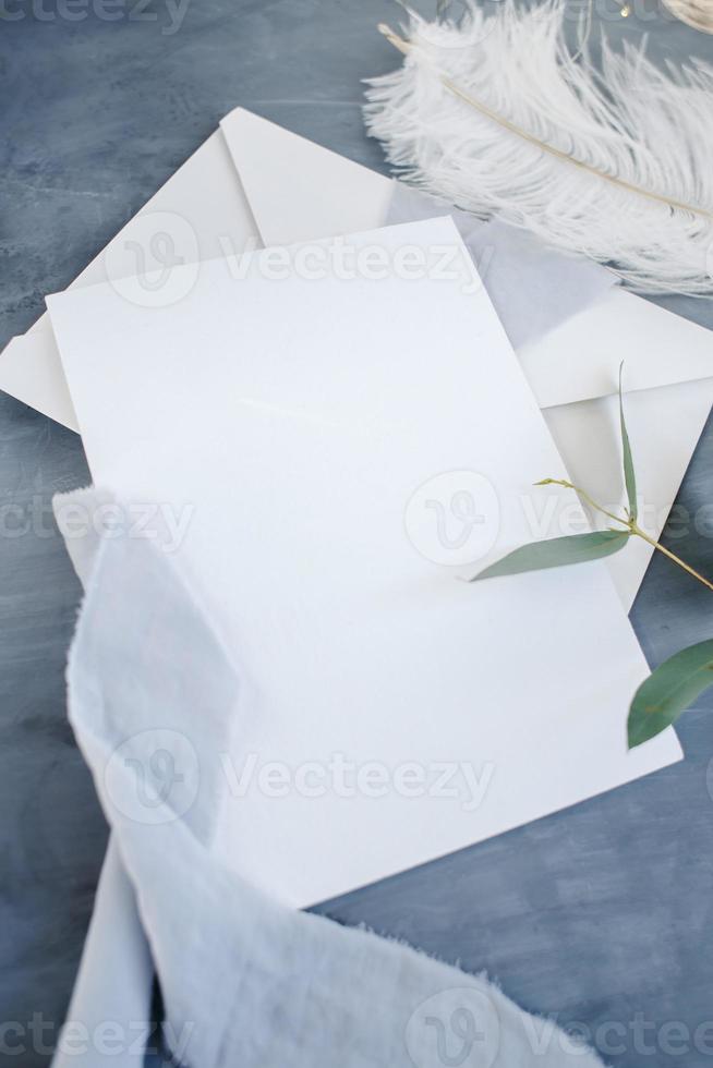 Blank paper copy space. Frame with flowers. Silk ribbon. Gray background. Simple bouquet. Greeting card. photo