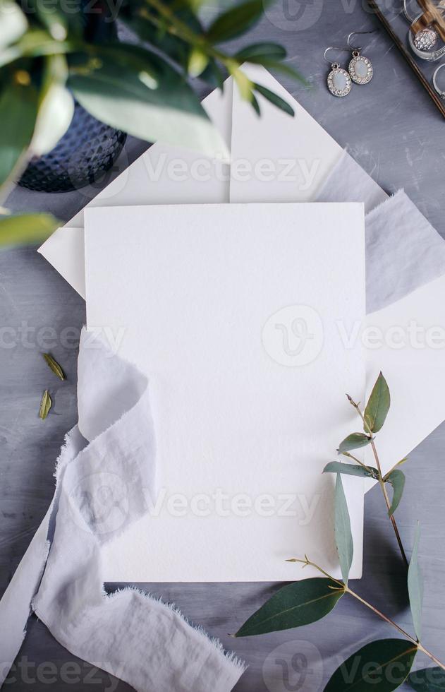 Blank paper copy space. Frame with flowers. Silk ribbon. Gray background. Simple bouquet. Greeting card. photo