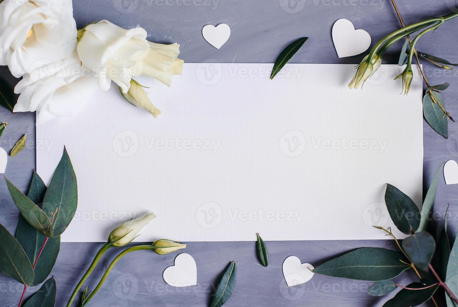 Blank paper copy space. Frame with flowers. Silk ribbon. Gray background. Simple bouquet. Greeting card. photo