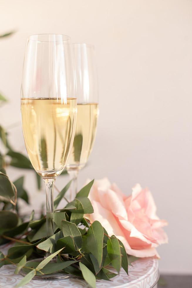 Composition with glasses of vine and flowers on grey concrete background. photo