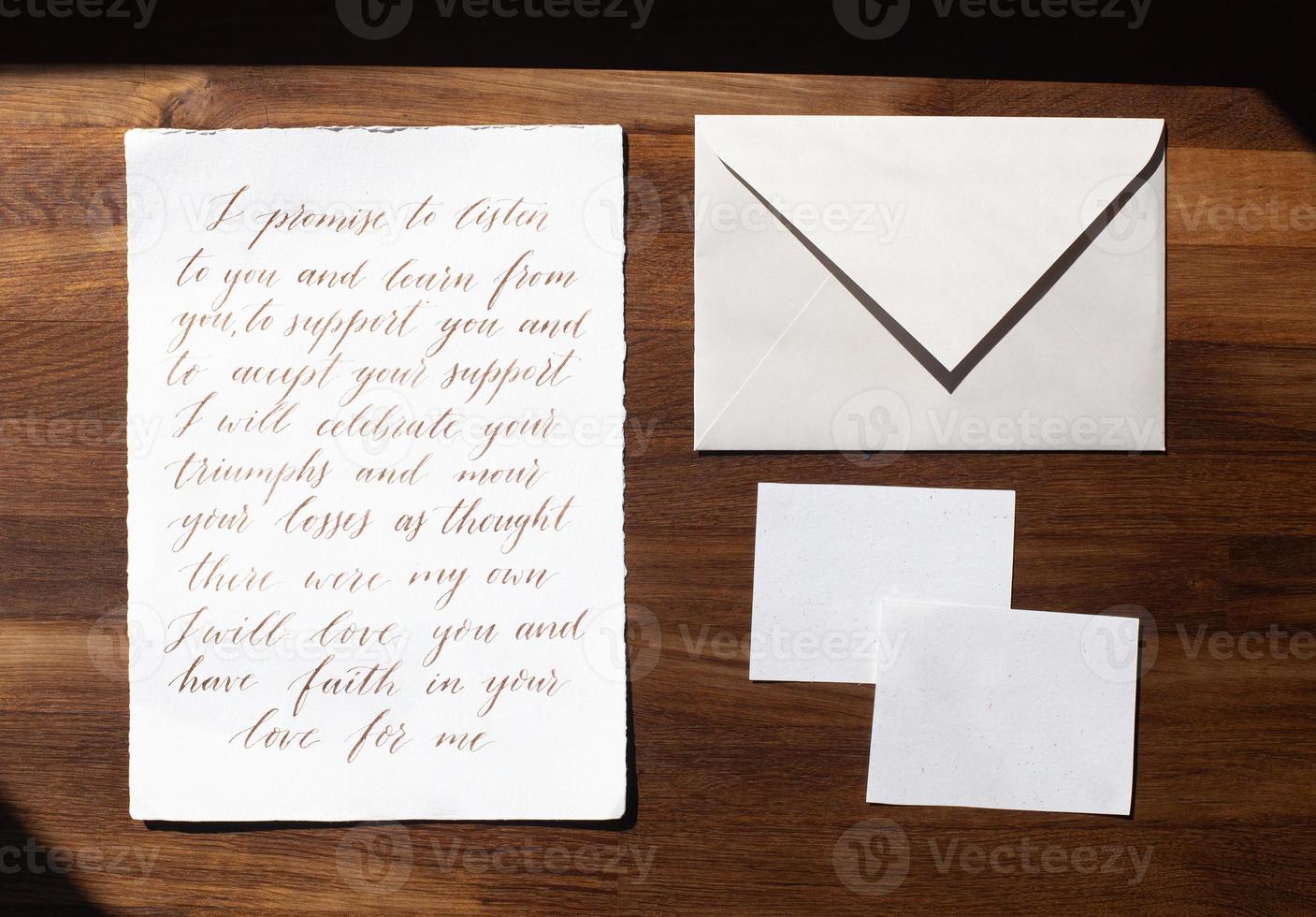 Wedding details flat lay on wooden background. Wedding invitation. Wedding bouquet. Mock up. Envelope. Copy space. photo