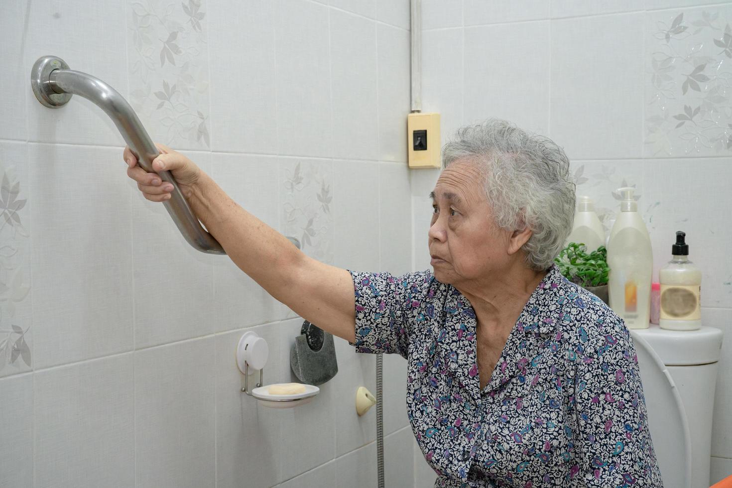 Asian senior or elderly old lady woman patient use slope walkway handle security with help support assistant in nursing hospital ward photo