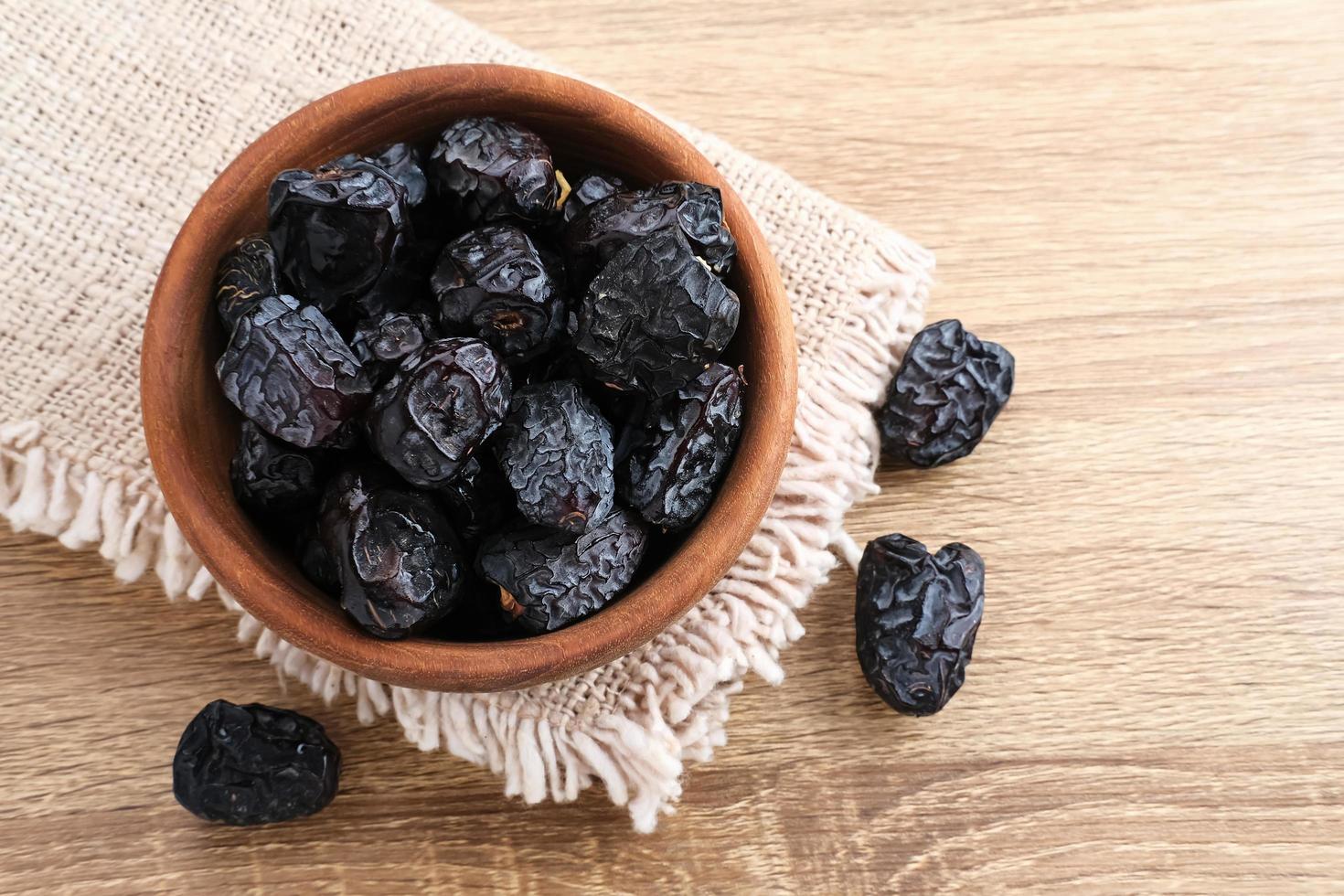 Kurma Ajwa, Ajwa Dates, served in wooden bowl. Kurma Ajwa is one of the special fruit of Arabic. photo