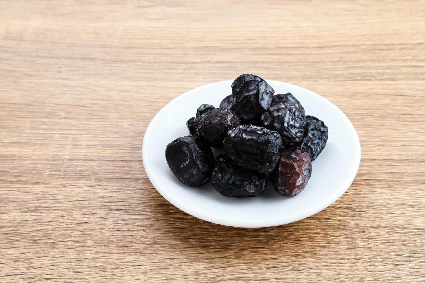 Kurma Ajwa, Ajwa Dates, served in small plate. Kurma Ajwa is one of the special fruit of Arabic. photo