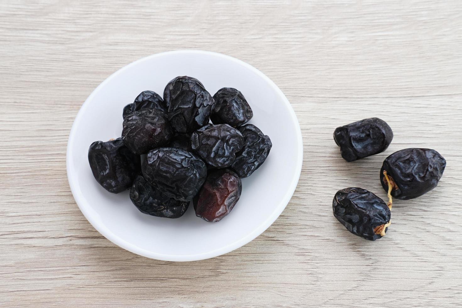 Kurma Ajwa, Ajwa Dates, served in small plate. Kurma Ajwa is one of the special fruit of Arabic. photo