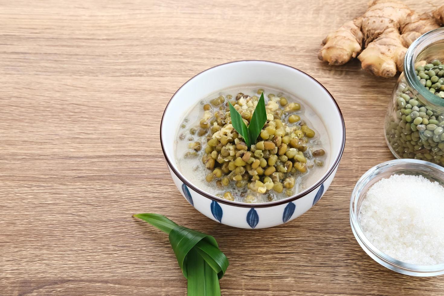 Mung Bean Porridge or Bubur Kacang Hijau, Indonesian dessert porridge of mung beans with coconut milk, pandan leaf and ginger. Served in bowl. photo