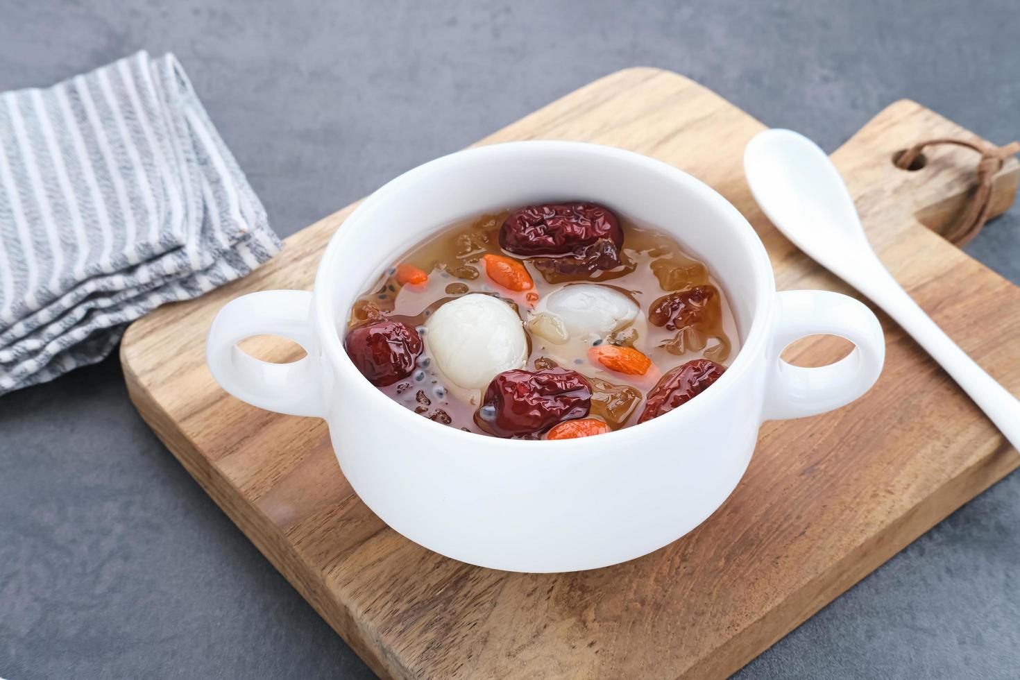 Chinese cuisine, a bowl of peach gum. Peach Gum is Chinese traditional drink that contains peach gum, bird nest, red dates, snow fungus, goji berry, and rock sugar. photo