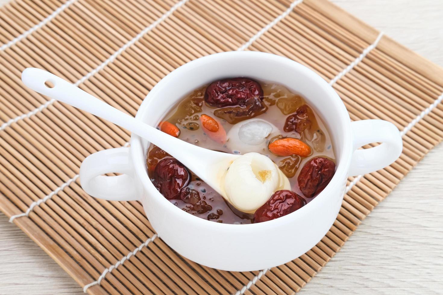 Chinese cuisine, a bowl of peach gum. Peach Gum is Chinese traditional drink that contains peach gum, bird nest, red dates, snow fungus, goji berry, and rock sugar. photo