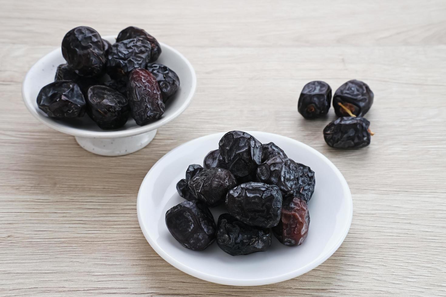 Kurma Ajwa, Ajwa Dates, served in small plate. Kurma Ajwa is one of the special fruit of Arabic. photo