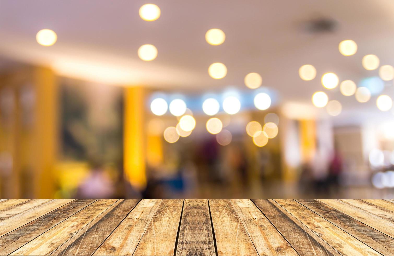 Old wooden table with blurred hotel lobby background photo