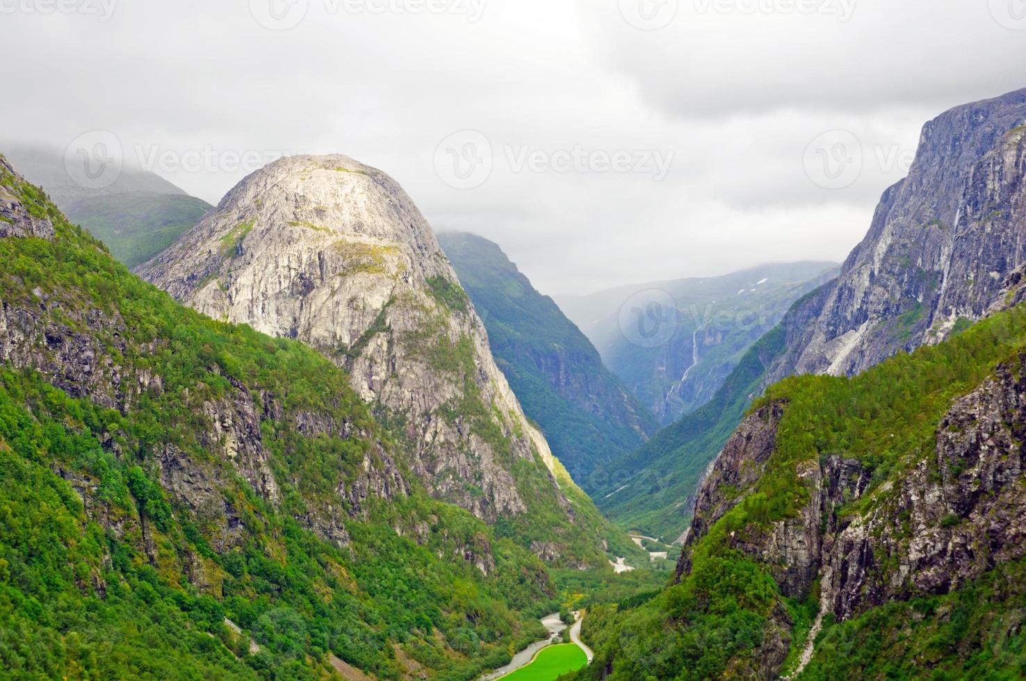Bald mountain in a verdant valley photo
