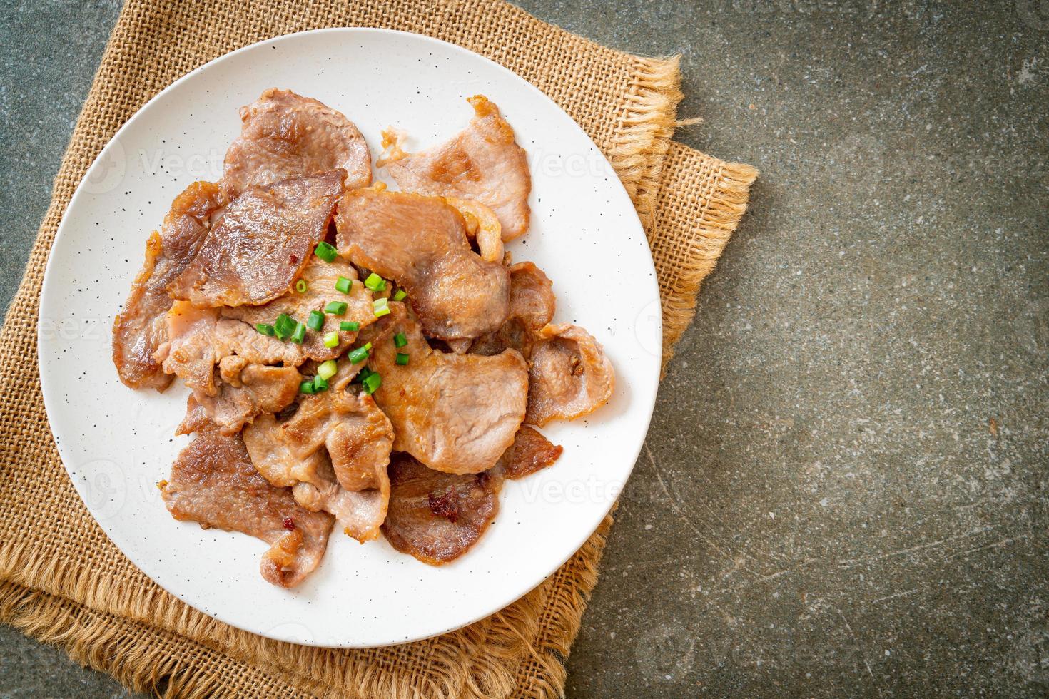 grilled pork neck sliced on plate photo