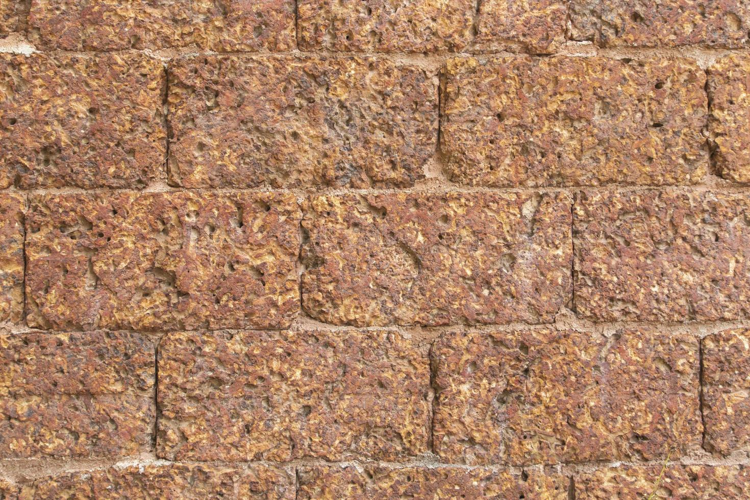 blur of red laterite brick wall Porous and finegrained Background