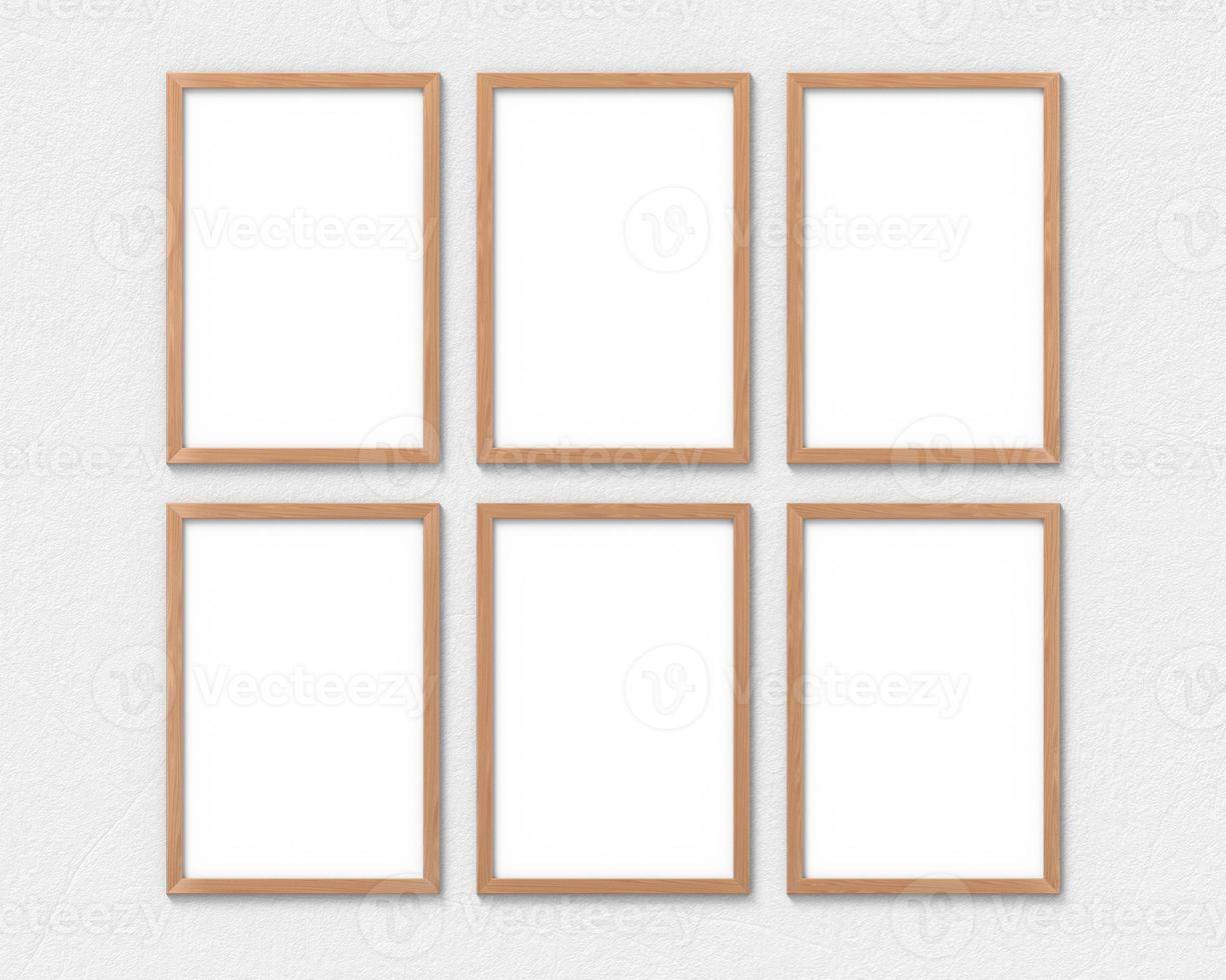 Set of 6 vertical wooden frames mockup with a border hanging on the wall. Empty base for picture or text. 3D rendering. photo