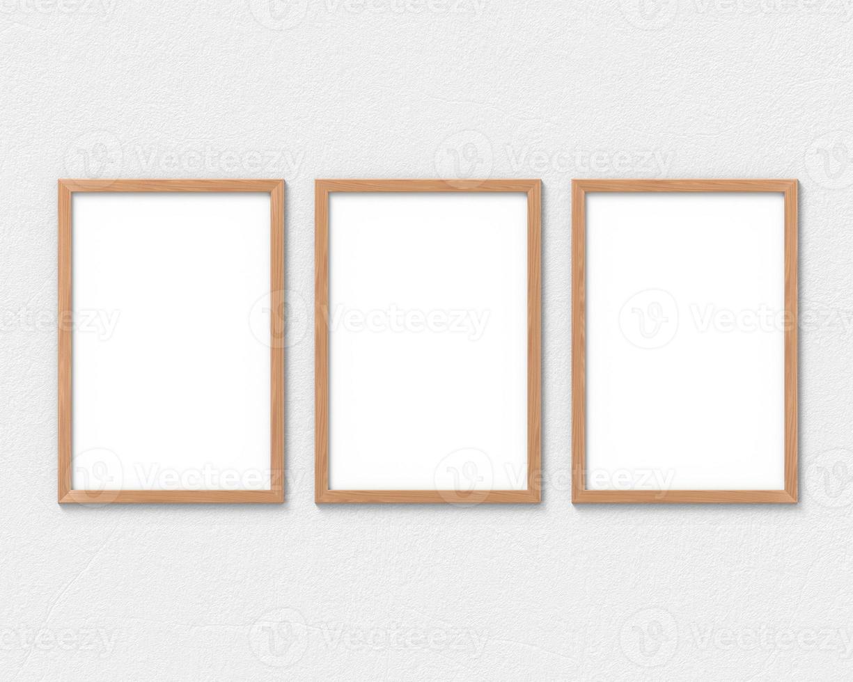Set of 3 vertical wooden frames mockup with a border hanging on the wall. Empty base for picture or text. 3D rendering. photo