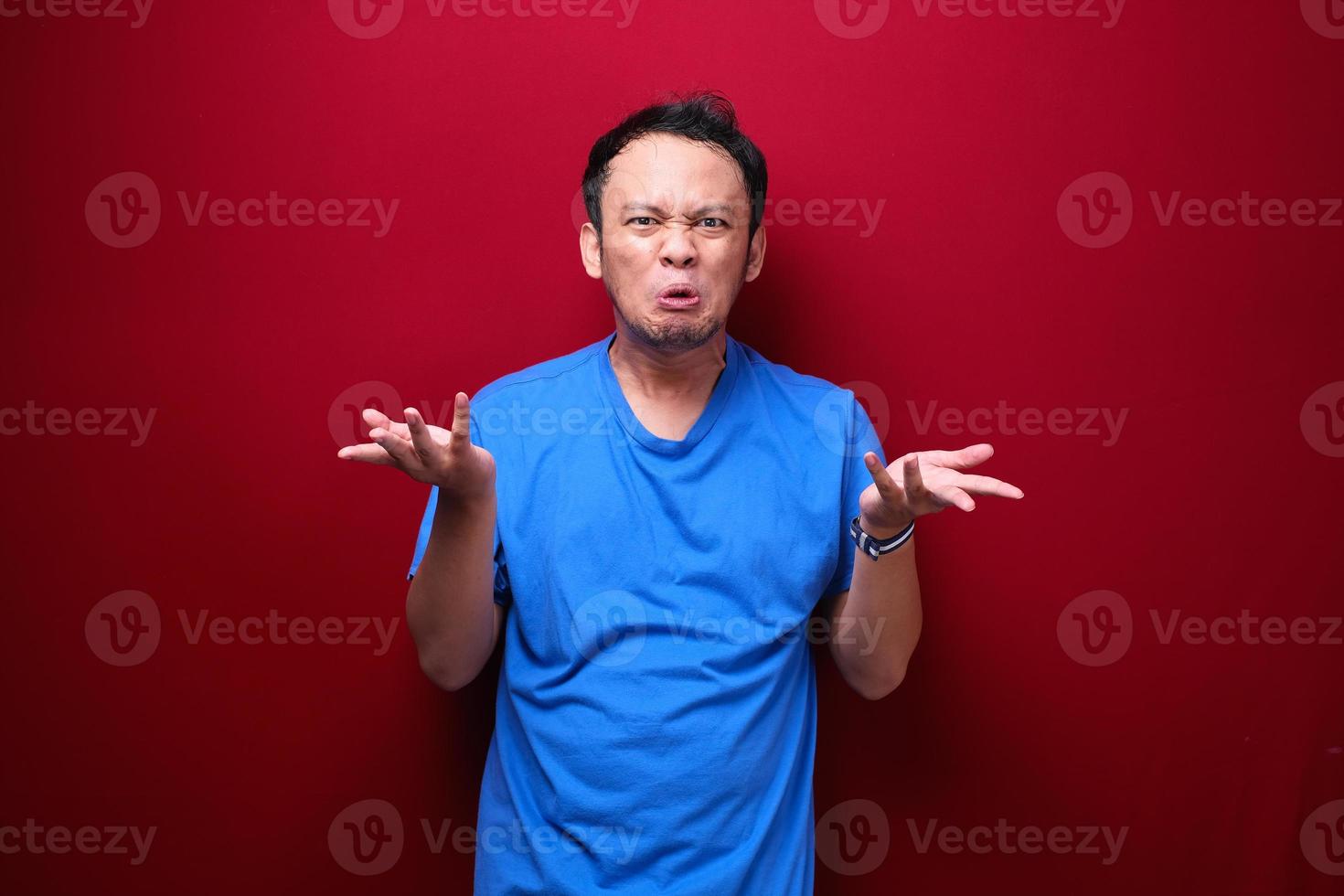 Angry and stress young Asian man raising his arm up. photo