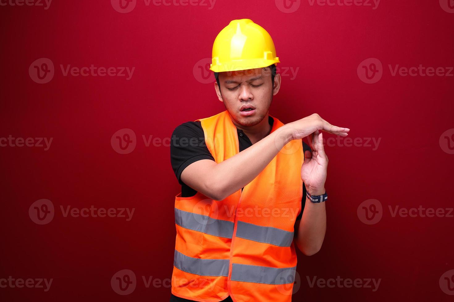 Tired and stress young asian man worker with tired hand gesture photo