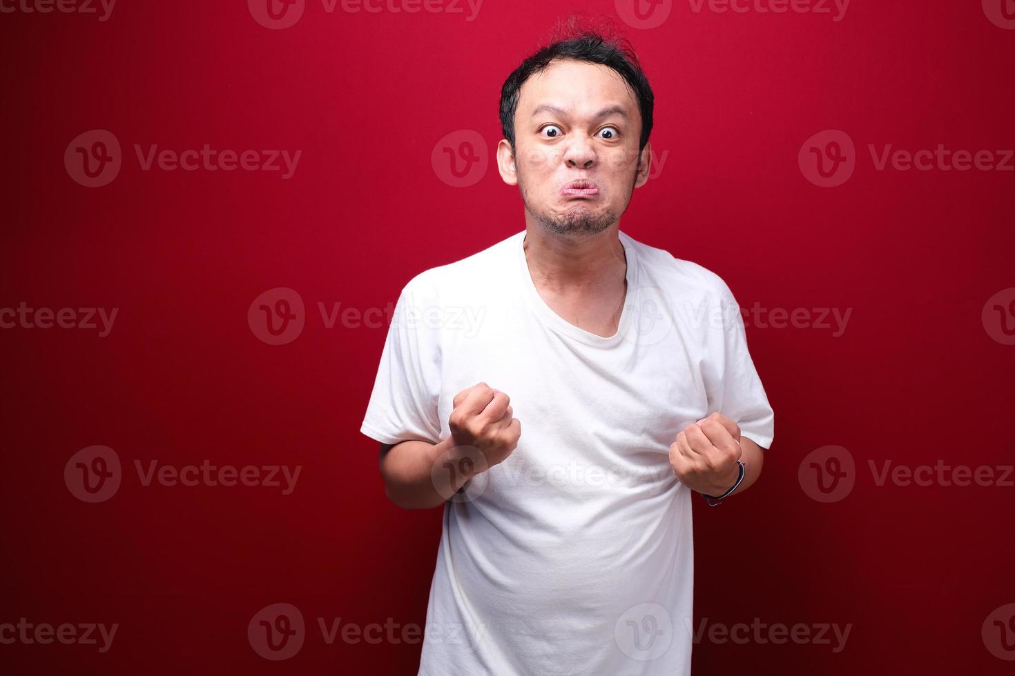 Angry and stress young Asian man raising his arm up. photo