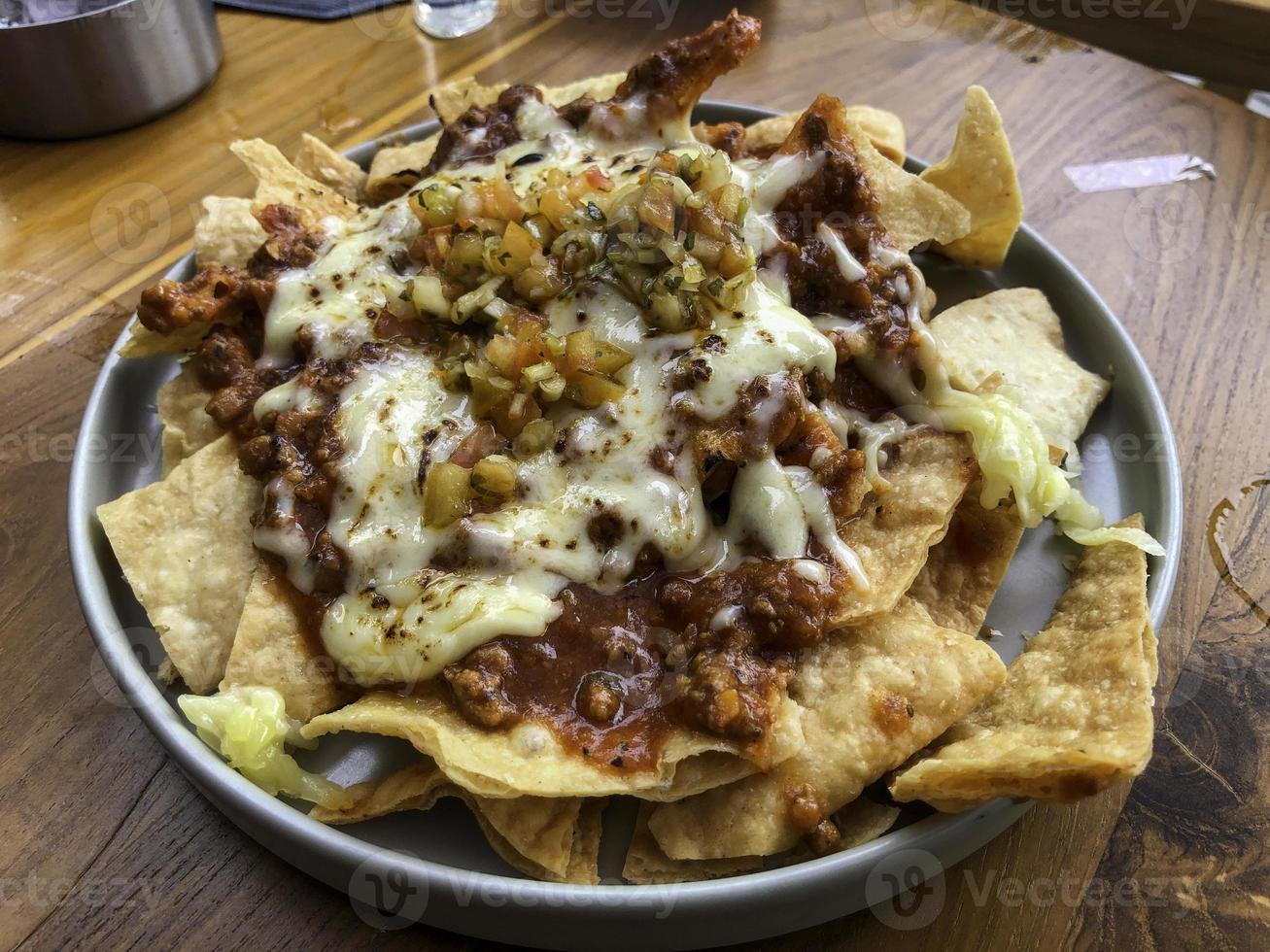 Nachos in a bowl with cheese ready to eat photo