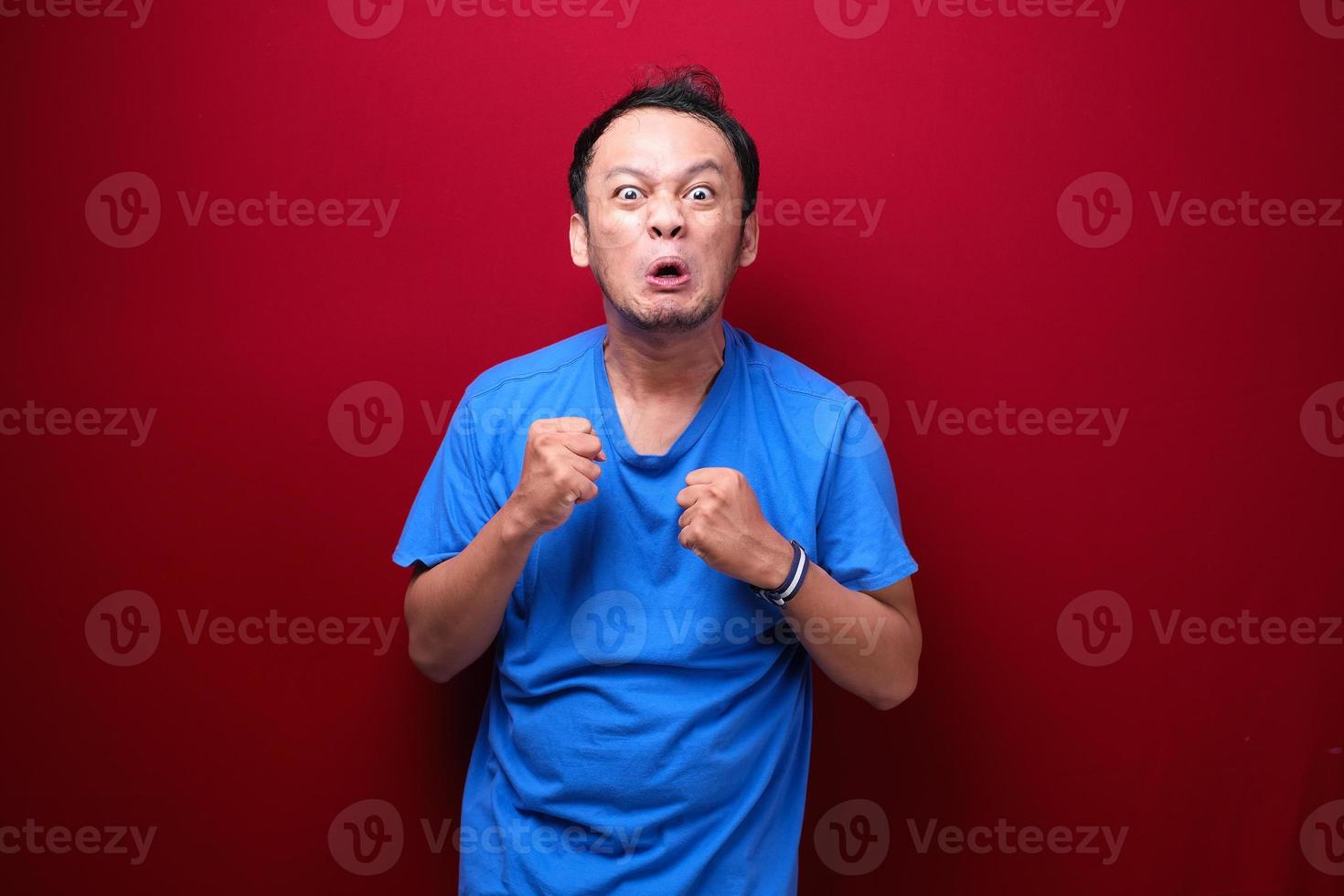 Angry and stress young Asian man raising his arm up. photo