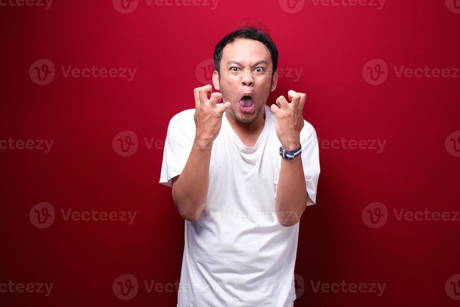 Angry and stress young Asian man raising his arm up. photo