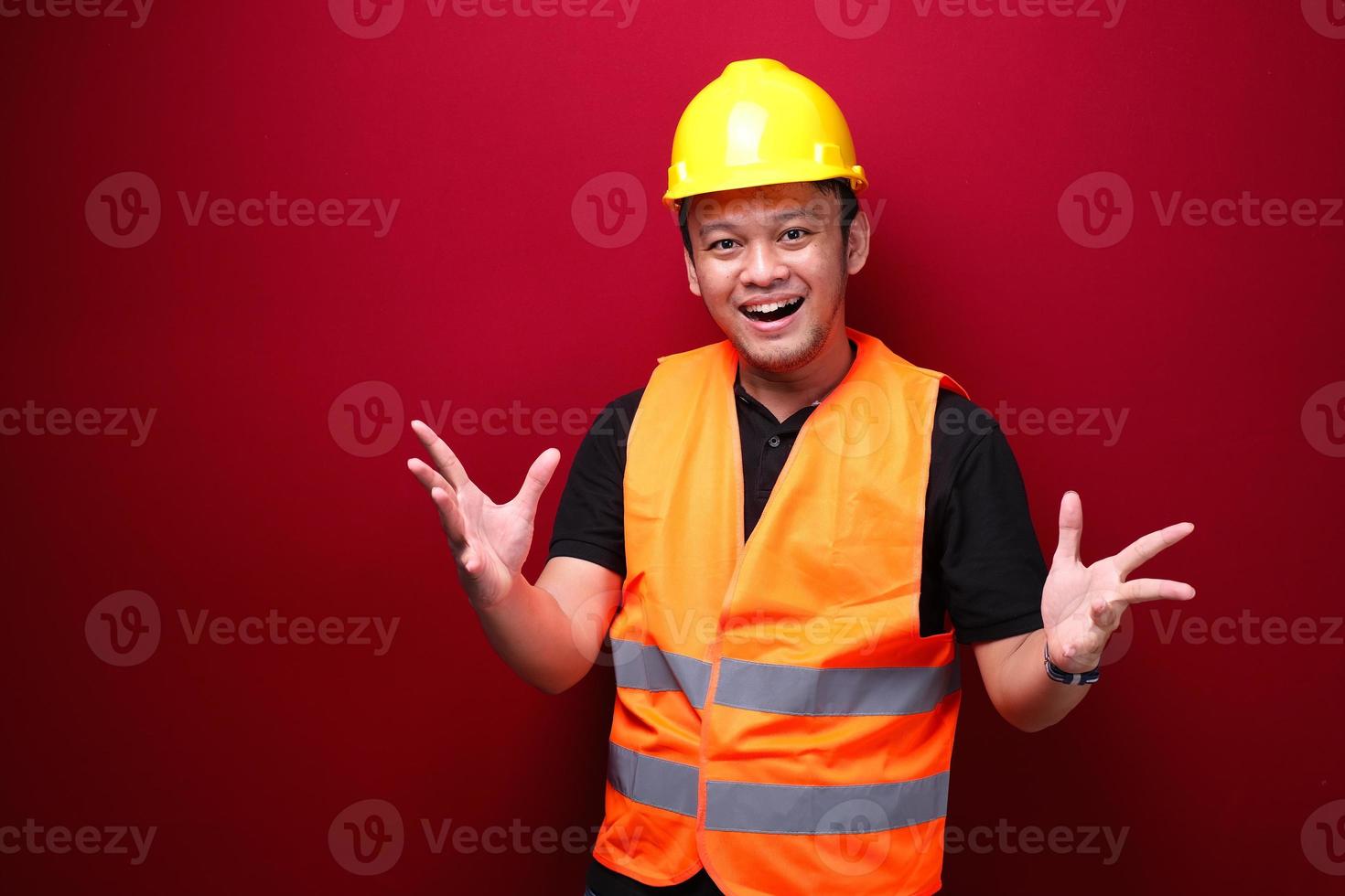 Young Asian Man worker is happy and smiling with open hand gesture photo