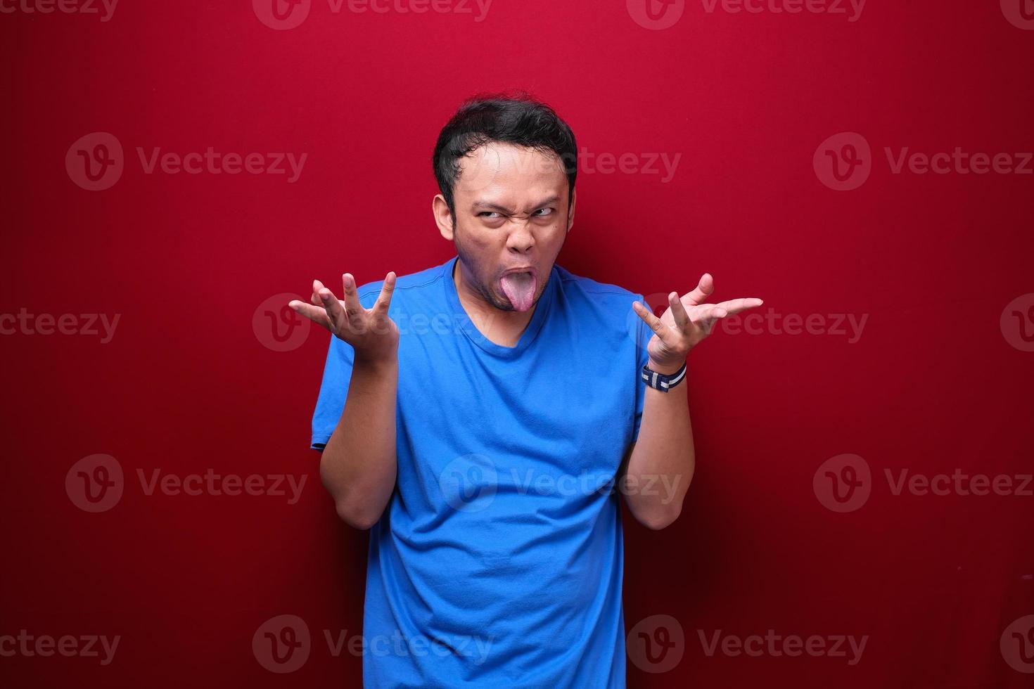 Angry and stress young Asian man raising his arm up. photo