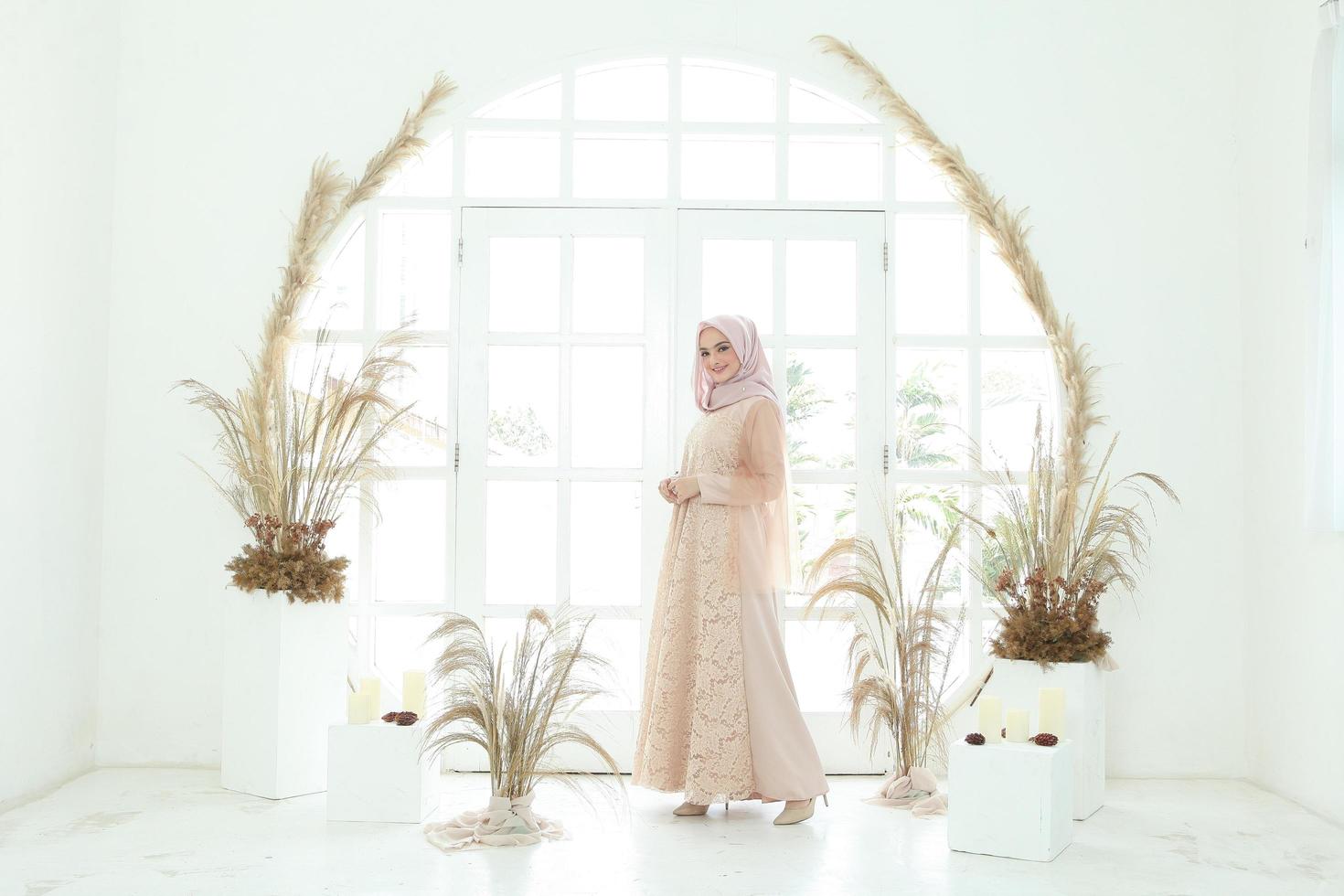 Full body portrait of lady use a wedding dress, wedding makeup on hijab. Malay or indonesia wedding dress, beauty or eidul fitri concept. Beautiful southeast asian muslim woman posing in islam dress photo