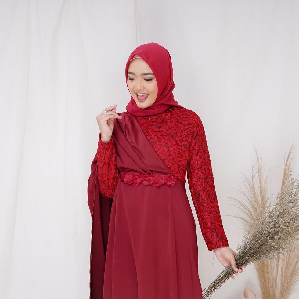 Beautiful islamic female model wearing hijab fashion, a modern lifestyle outfit for muslim woman. Concept a wedding dress, beauty or eidul fitri. A asian girl model wearing hijab on indoor photoshoot photo