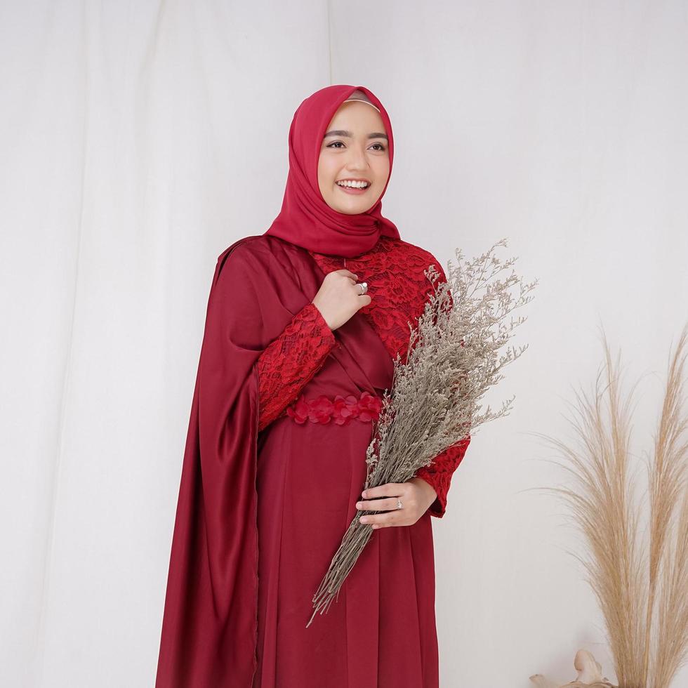 Beautiful islamic female model wearing hijab fashion, a modern lifestyle outfit for muslim woman. Concept a wedding dress, beauty or eidul fitri. A asian girl model wearing hijab on indoor photoshoot photo