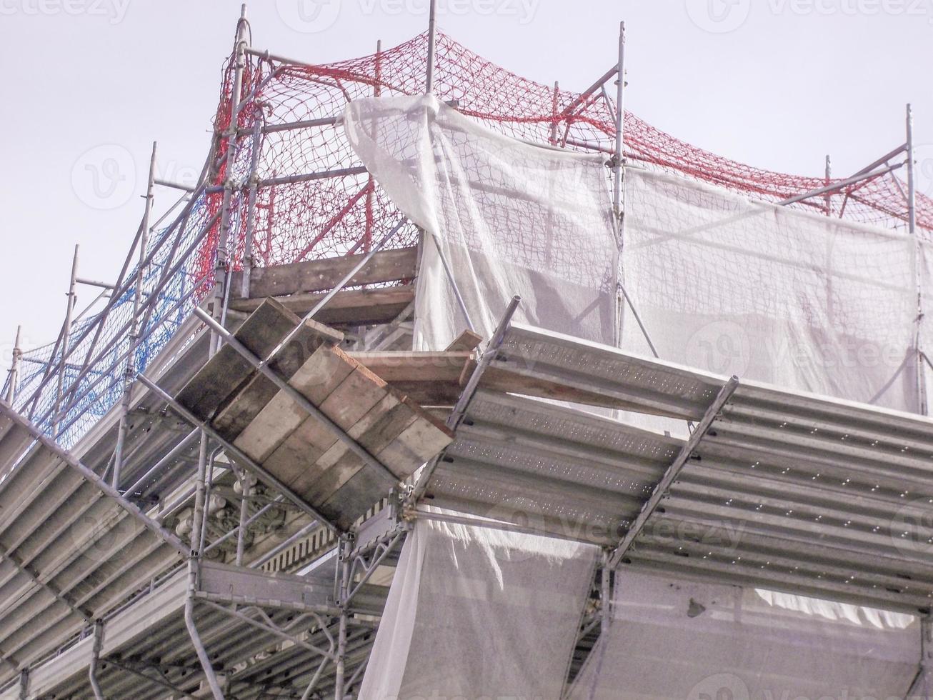 Temporary scaffold for construction works at building site photo