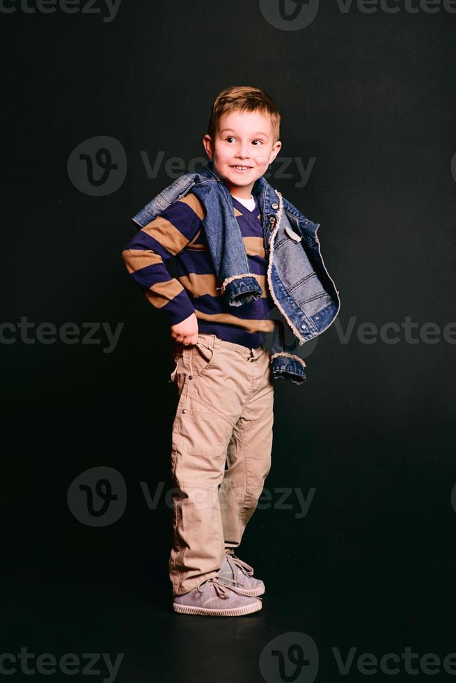 portrait of stylish cute little boy in photo studio