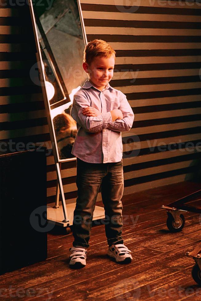 portrait of stylish cute little boy in photo studio