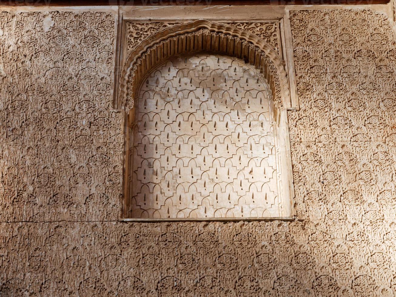 Close up detail of filigree walls, arches. Detailed handcraft of Moorish Architecture. Travel in time and discover history. Historic destination. Beautiful background and textures. photo