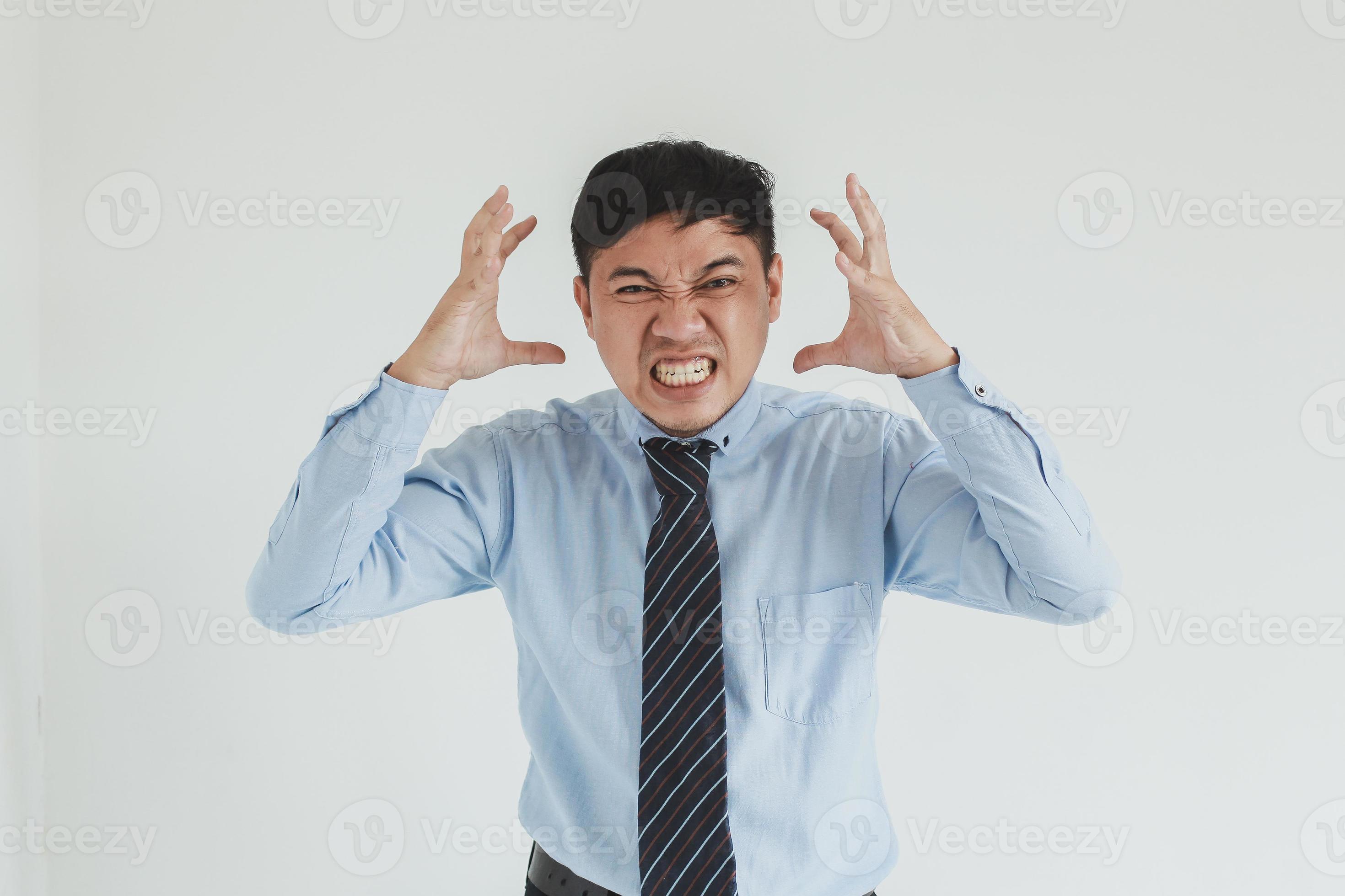 Frustrated sales man wearing blue shirt and tie posing with angry face