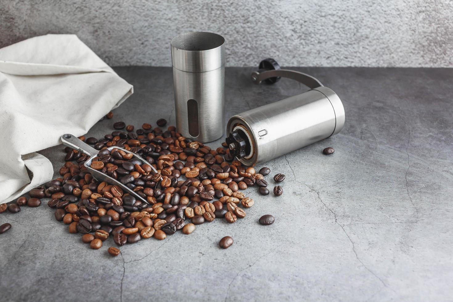 Hand coffee grinder and coffee beans on the table photo