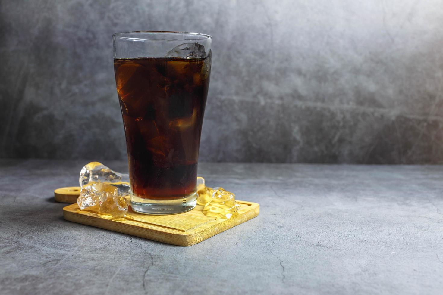 black soft drink in a glass photo