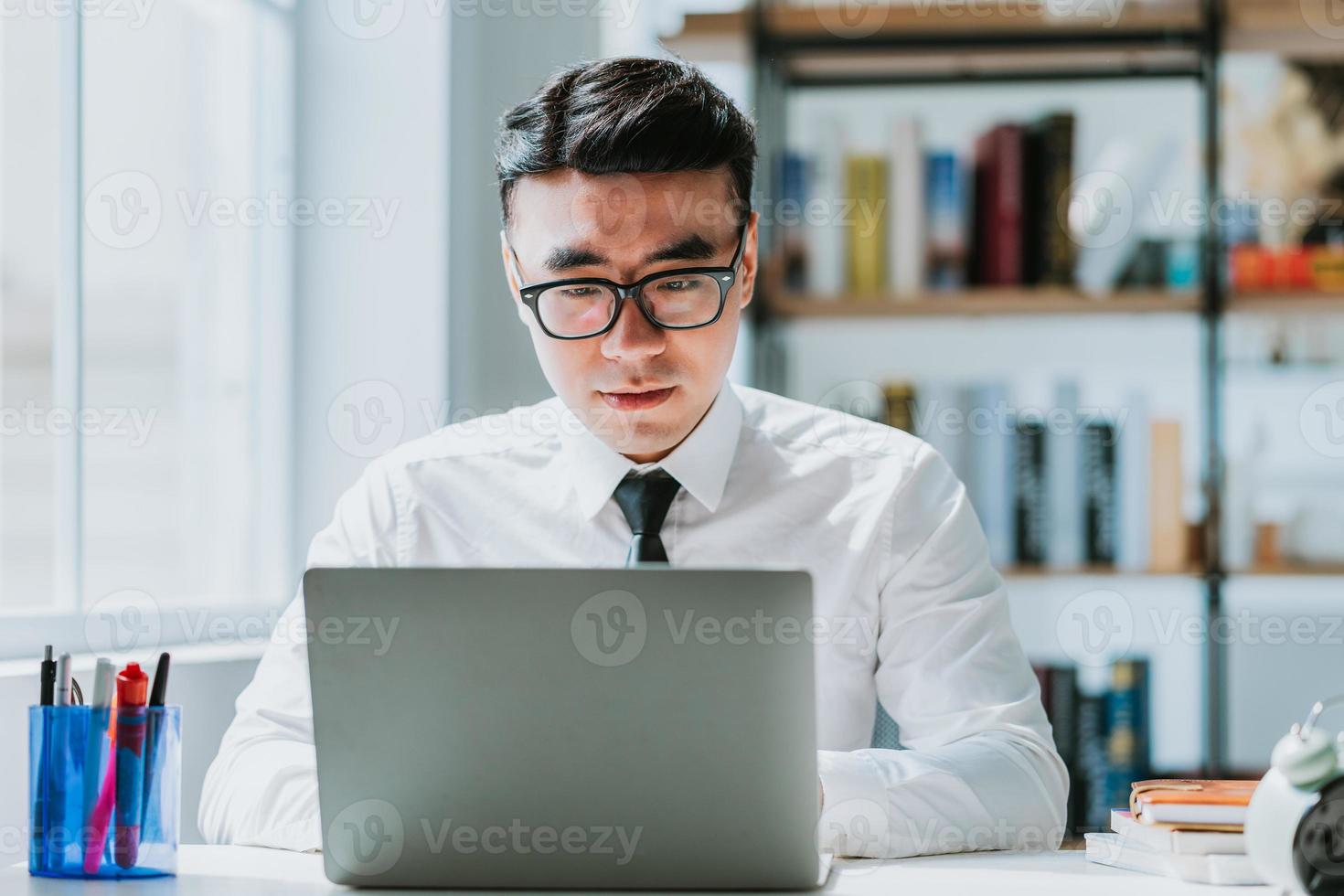 Young Asian businessman working at office photo