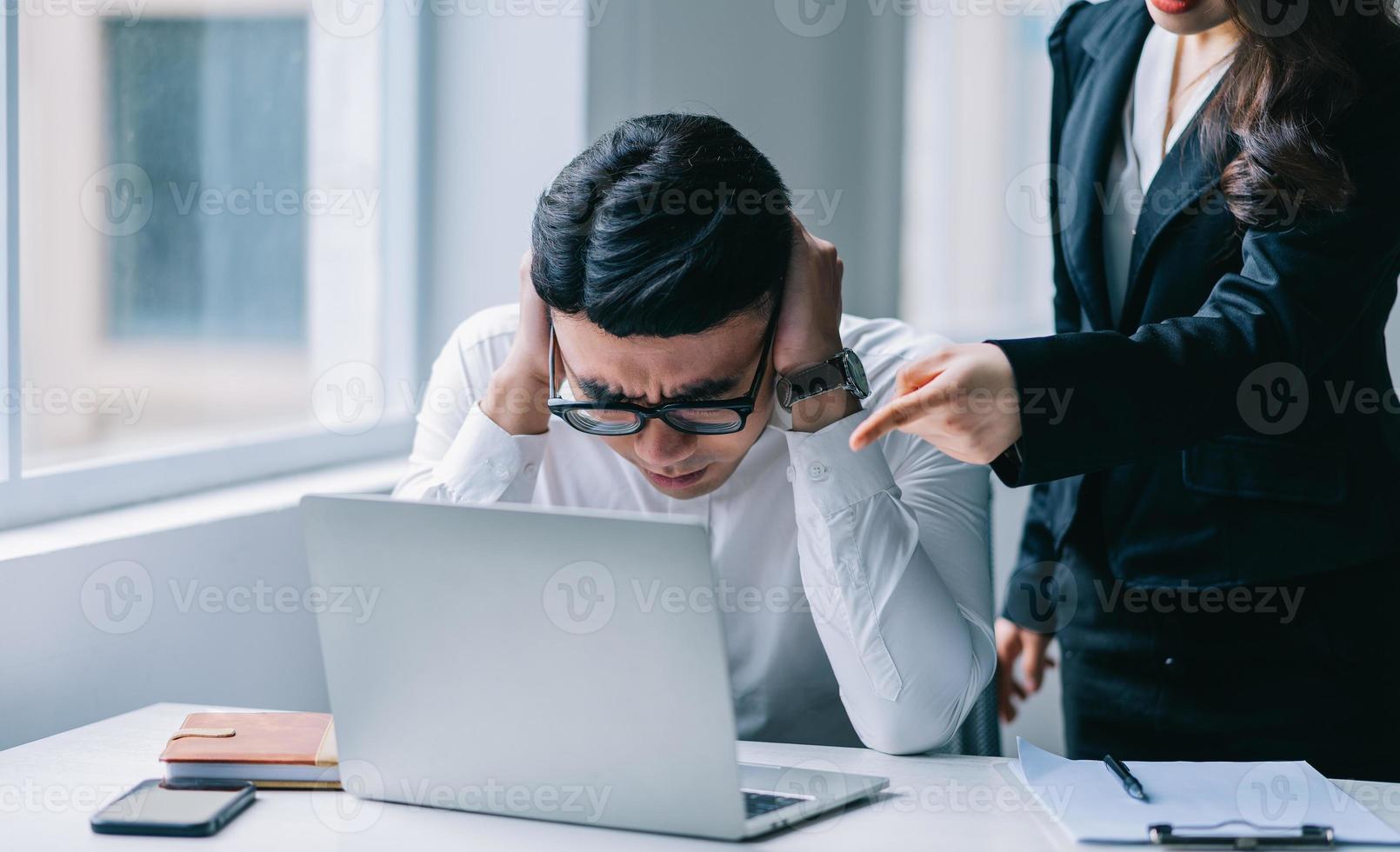 Two Asian colleagues are having a heated argument with each other photo