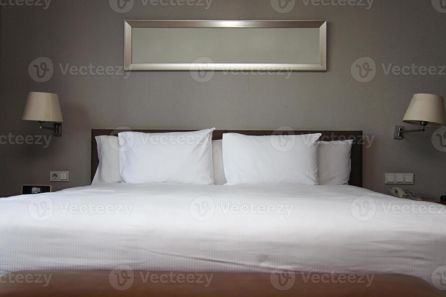 Tidy white king size bed in bedroom photo