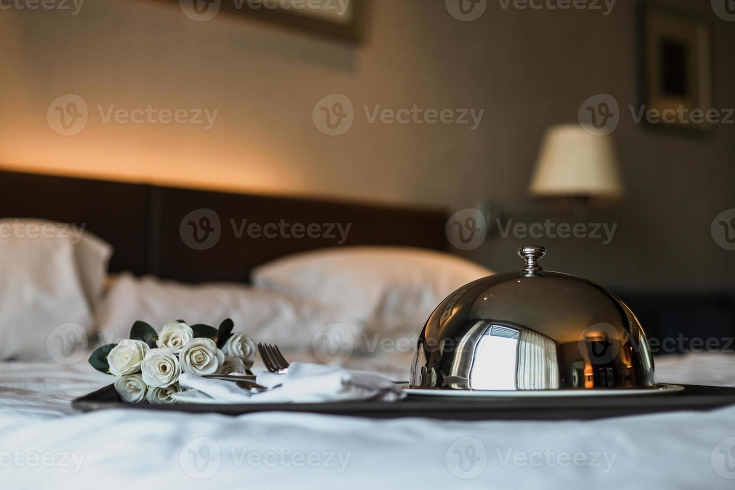 Romantic dinner on the bed with flowers bucket photo