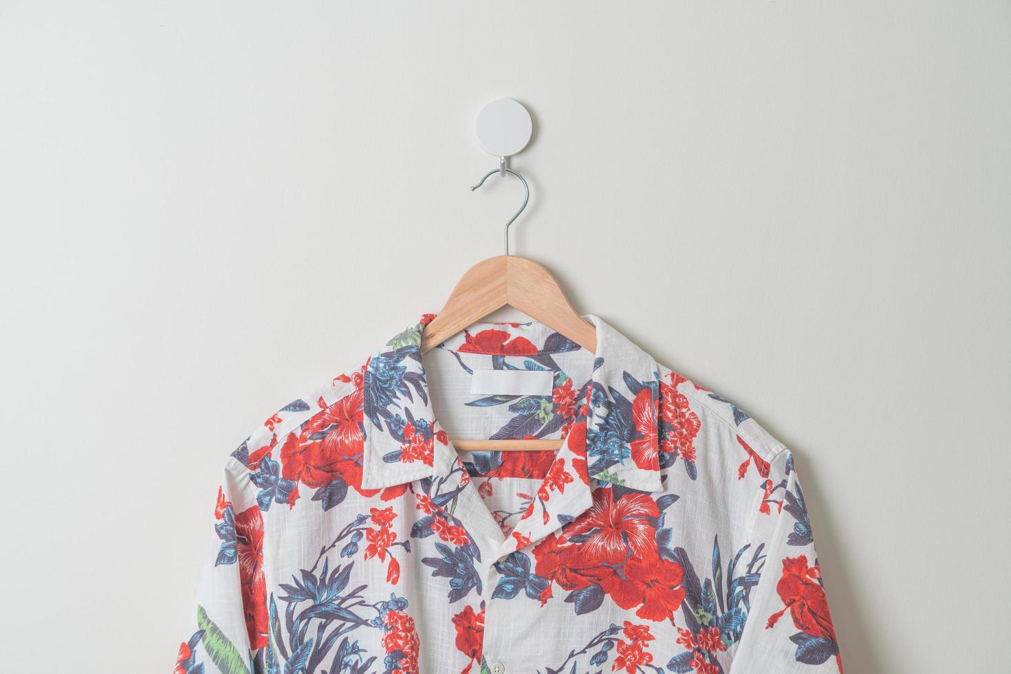 hanging shirt with wood hanger on wall photo