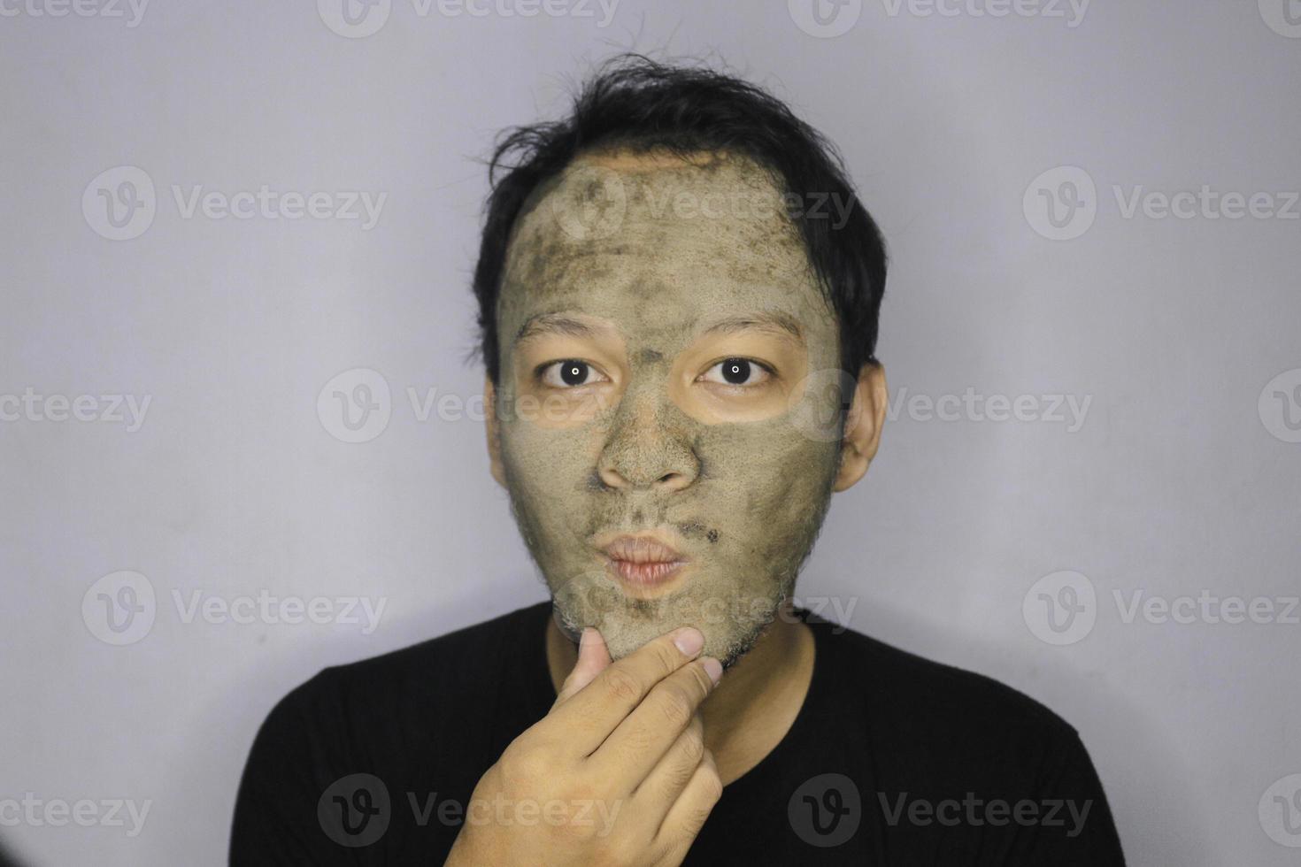 Asian Man was thinking and day dreaming when he use beauty face mask photo