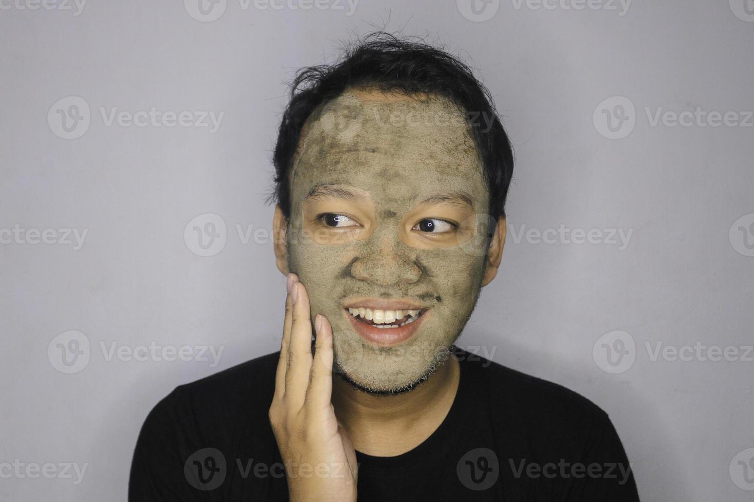 Asian Man was thinking and day dreaming when he use beauty face mask photo