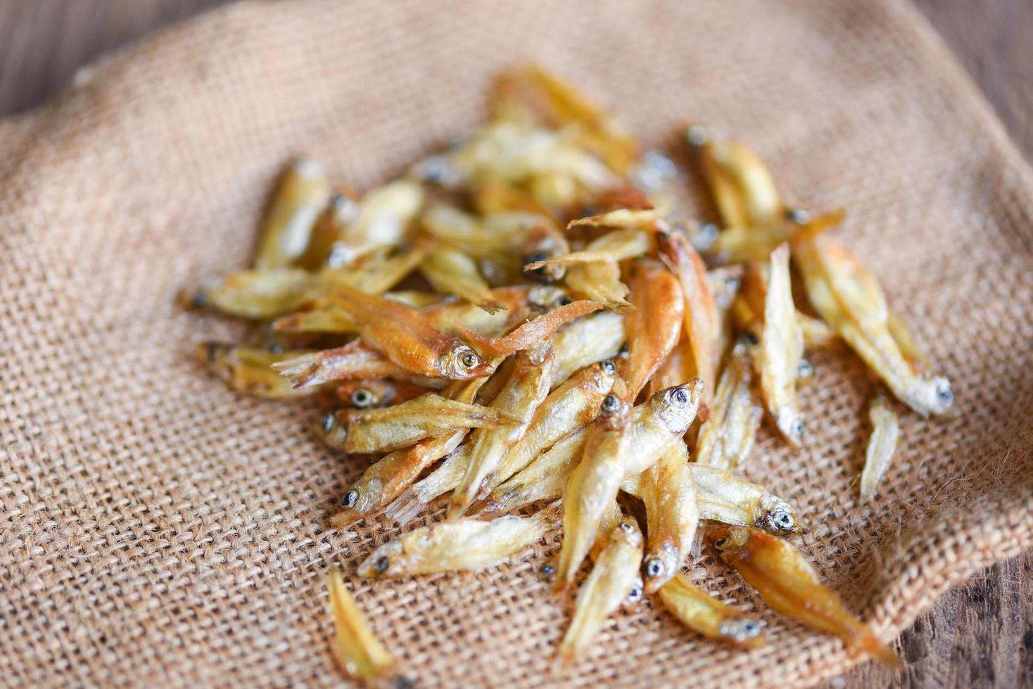 Small dried fish on the sack background, Crispy fish for snack photo