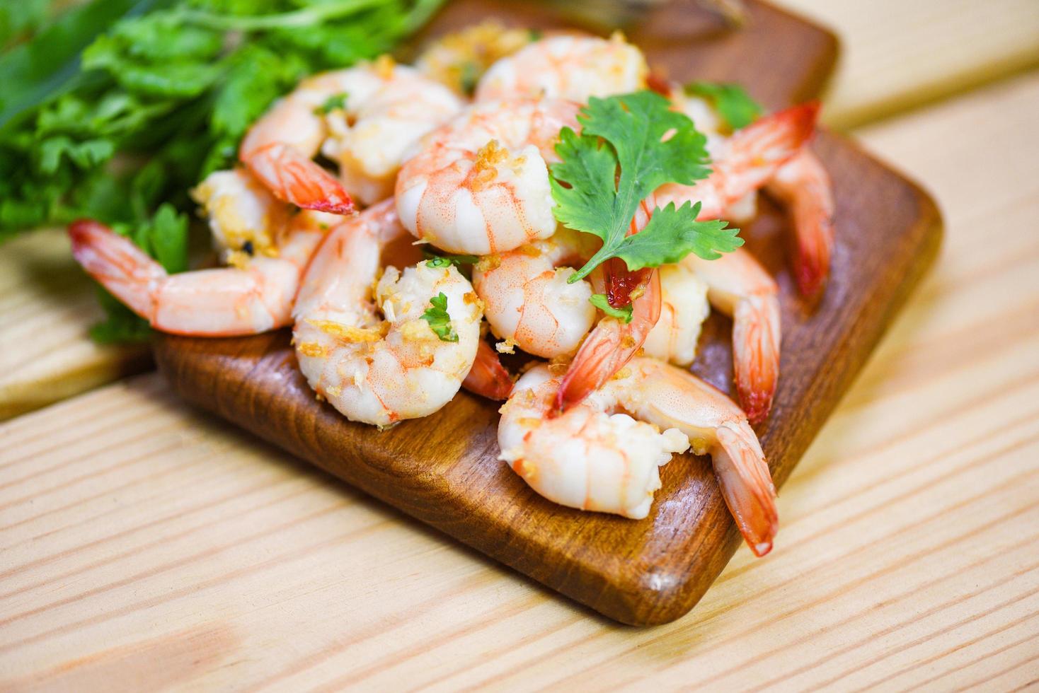 Shrimp delicious seasoning spices on wooden cutting board background - cooked shrimps or prawns , Seafood shelfish photo