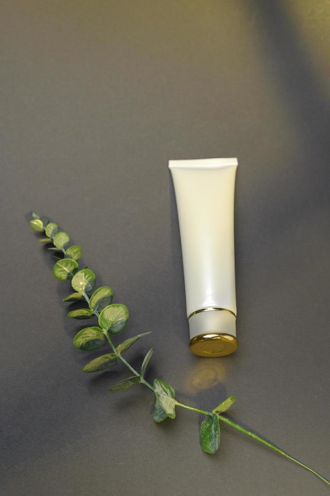 moisturizing cream bottle over black background studio, packing and skincare beauty concept photo
