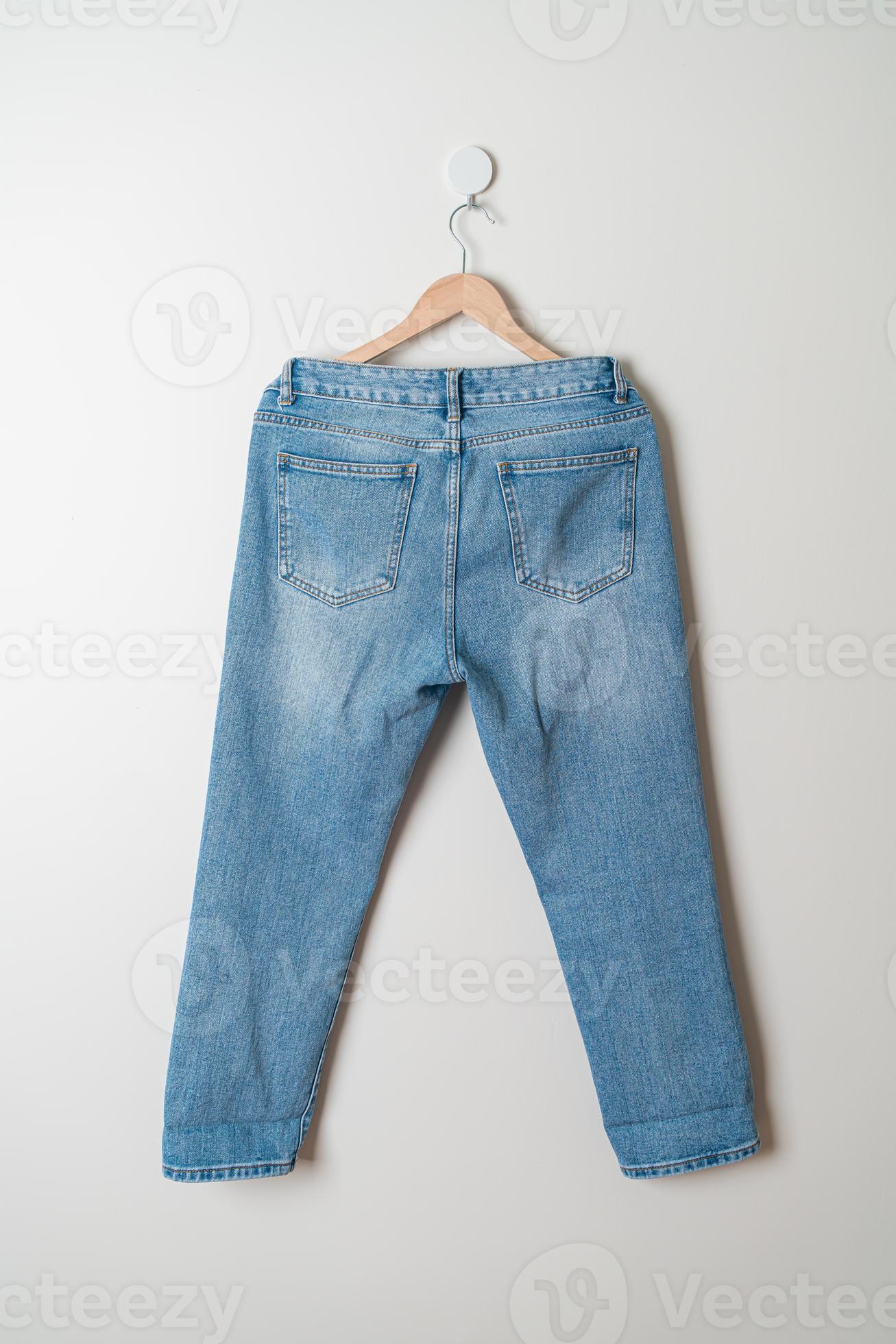 jeans trousers hanging on wall 6455040 Stock Photo at Vecteezy