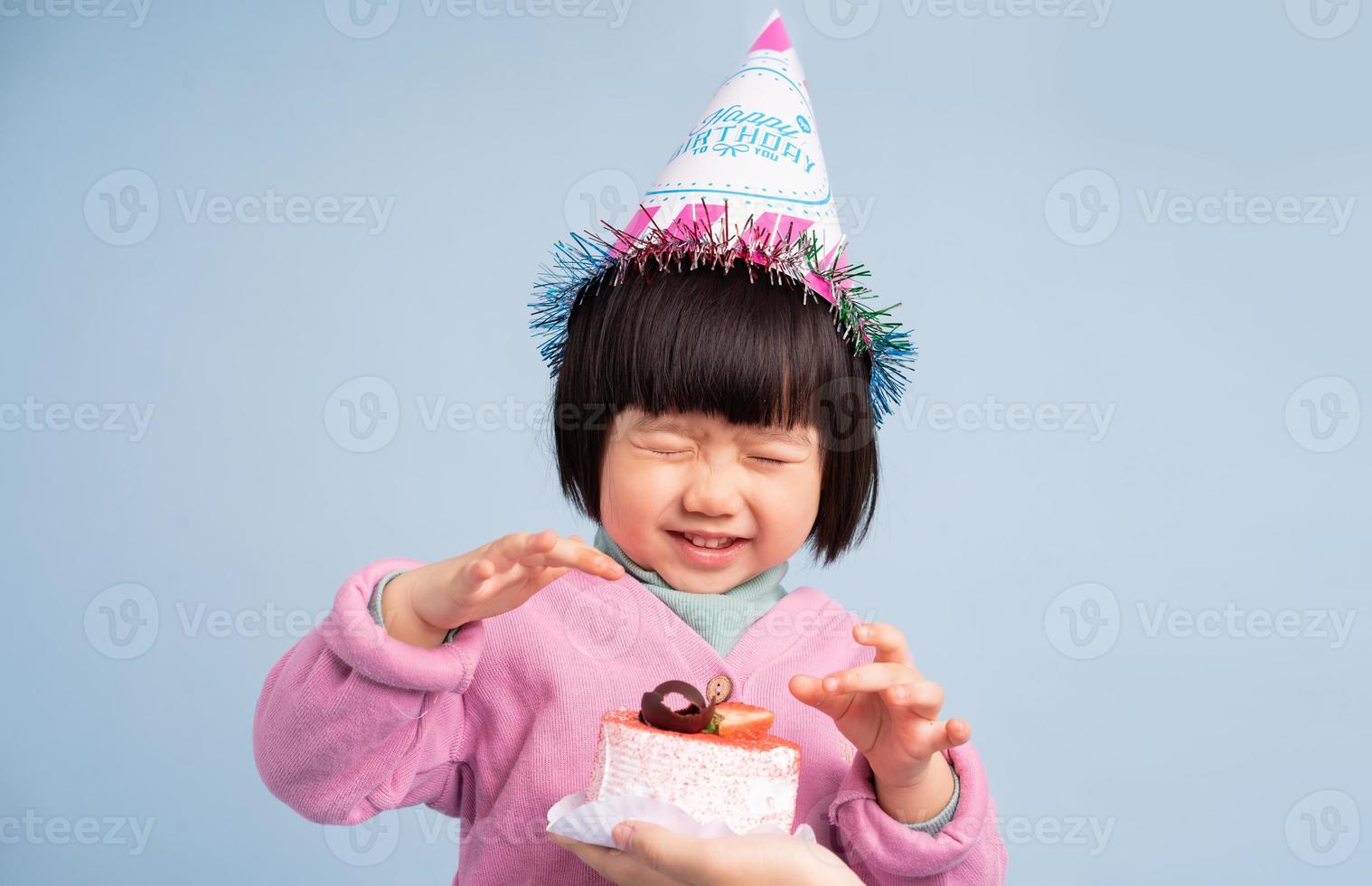 lovely baby girl portrait, isolated on blue background photo